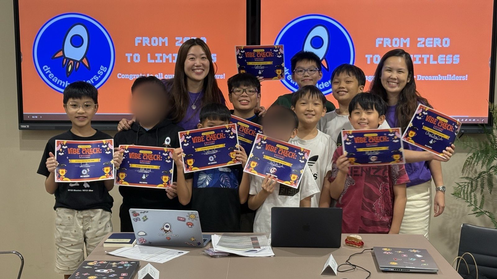 Cohort Zero Batch B holding up their certificates in front of the From Zero to Limitless backdrop